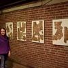 Laura with fragments of 1930s newspapers found in the building.